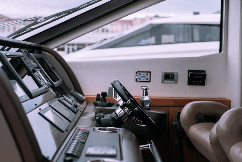 Interior of a luxury yacht showing steering wheel and advanced controls.
